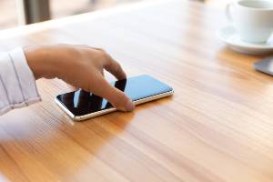 reaching for smartphone on table