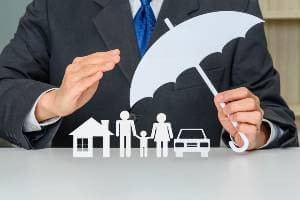 business person holding umbrella icon over family