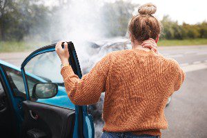 woman grabbing neck right after car crash