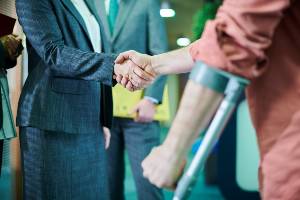 injured man shaking woman's hand