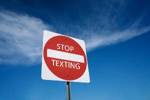 road sign against texting and driving