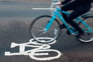 riding blue bicycle on road