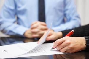 signing documents at table