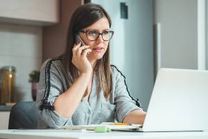 woman making phone call at desk