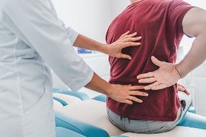 doctor with patient with back pain