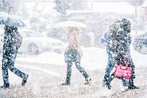 snowy day with pedestrians walking