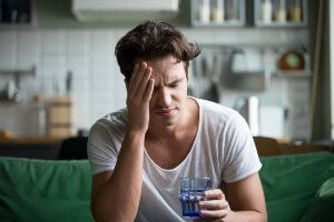 tired man sitting on couch