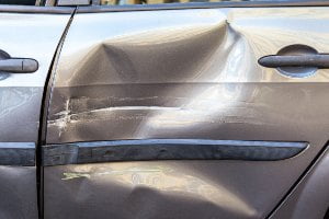 dent on silver car door