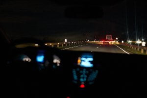 car on highway at night with traffic ahead