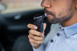 driver taking breathalyzer test