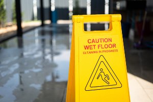 yellow sign warning of wet floor