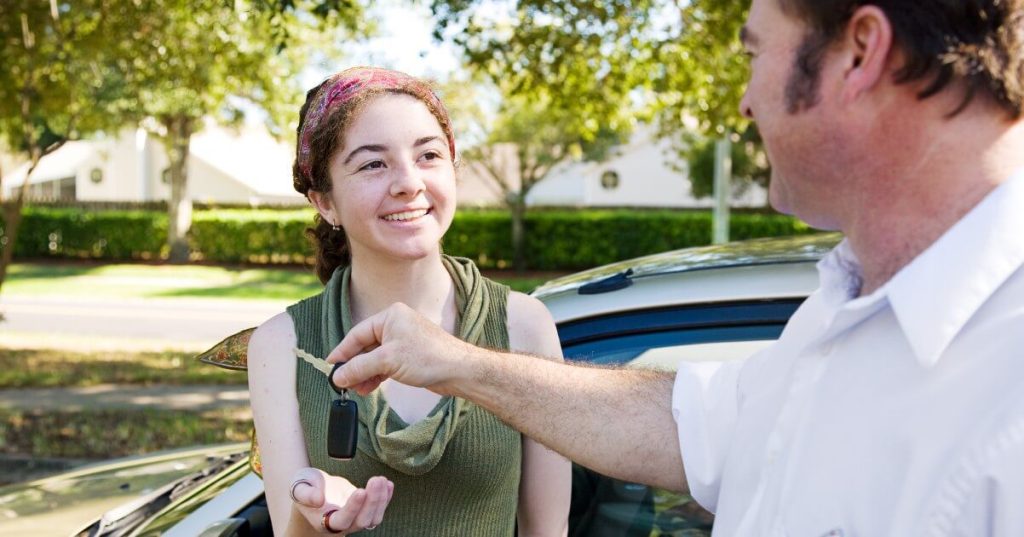 Current image: father handing car keys to daughter