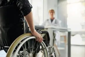person in wheelchair visiting medical provider