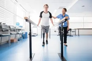 young man with prosthetic leg in physical therapy