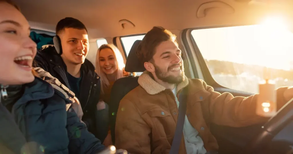 Current image: car full of teenaged drivers in winter coats, buckled up and looking happy