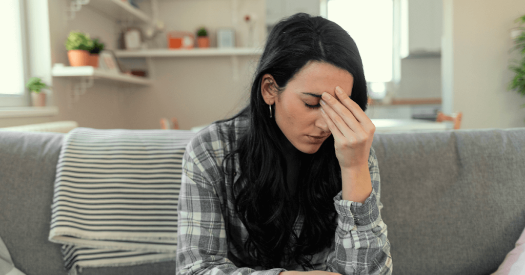 Current image: Woman Sitting on Couch with Headache Social