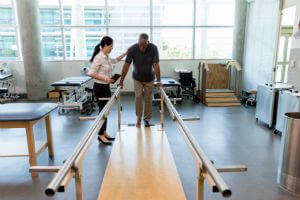 physical therapist working with patient