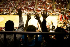 fans doing the wave at basketball game
