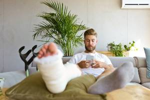 man making phone call from couch