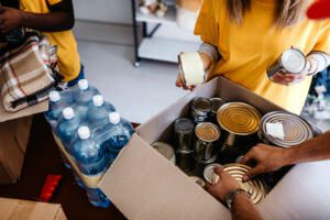 filling a box with cans