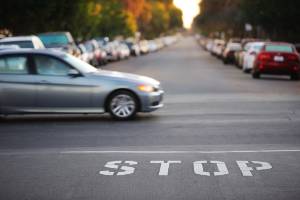 car crossing intersection in front of stop line