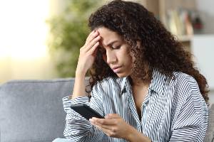 concerned woman looking at phone