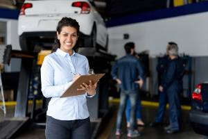 helpful assistant by cars at repair shop