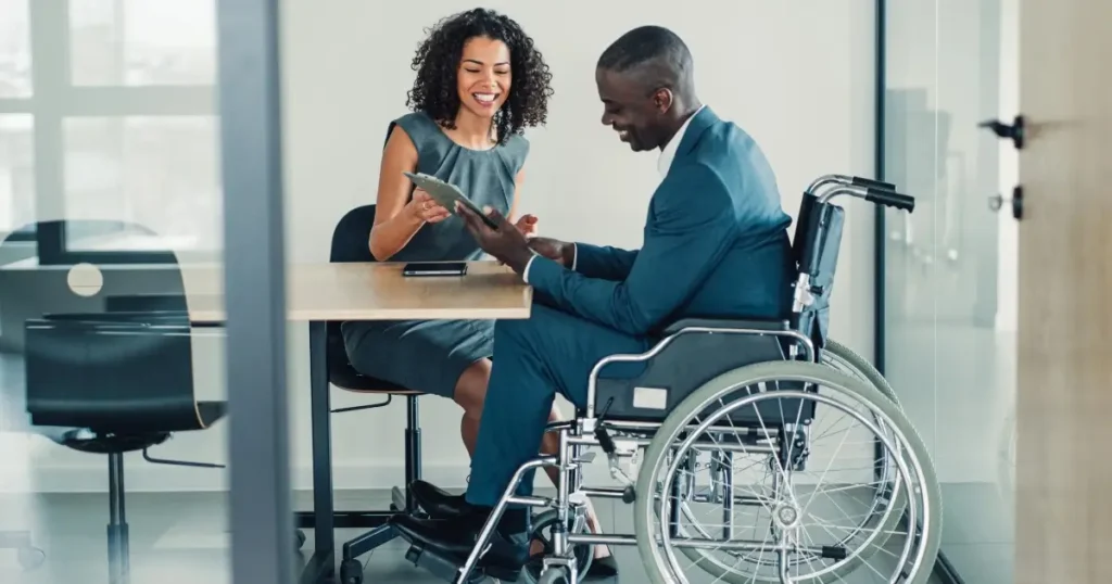 Current image: Woman reviews information with young man in wheelchair