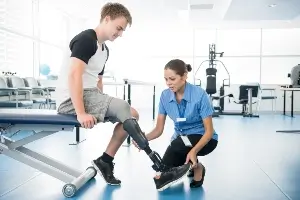 young man with prosthetic leg in physical therapy