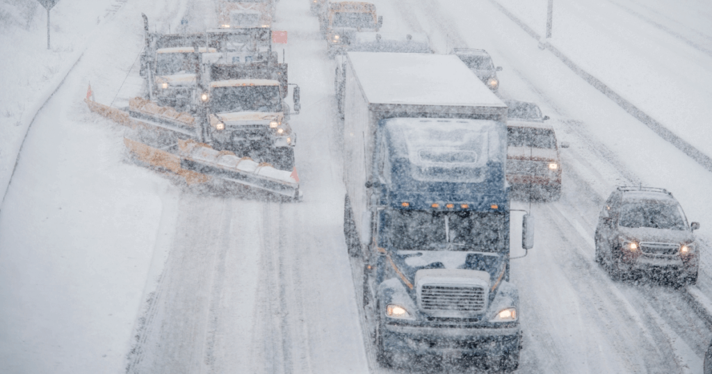 snowplows on snow-covered highway