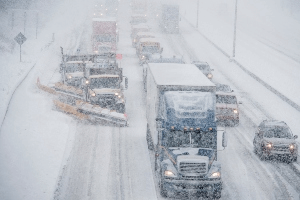 snowplows on snow-covered highway